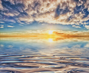 Naklejka na ściany i meble Dawn or dusk reflected on ripples on large body of water