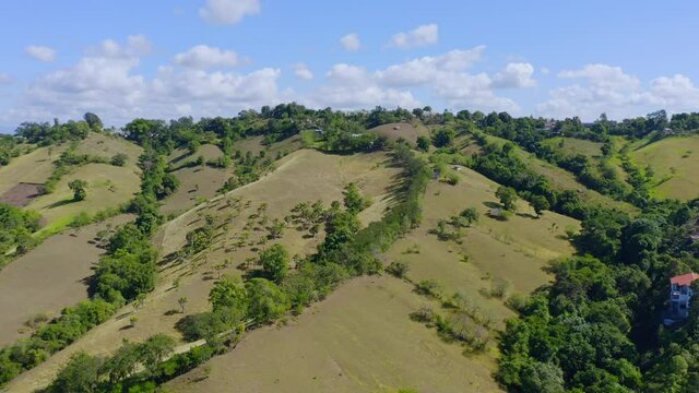 Lush Green Hills In El Caimito, Dominican Republic At Daytime - aerial drone shot