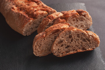 sliced bread lying on black board for serving