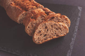 Baguette of buckwheat flour without yeast on a black background