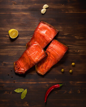 Smoked salmon fish on a dark wooden board