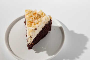 Sliced piece of cacao cake with nuts