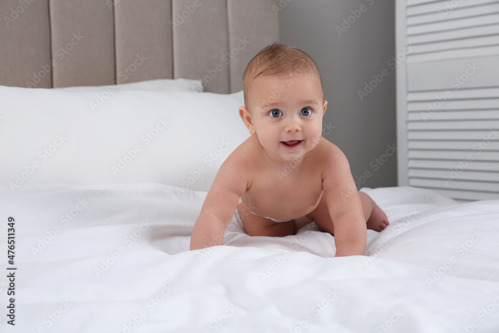 Wall mural Cute baby in dry soft diaper on white bed at home