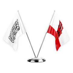 Two table flags isolated on white background 3d illustration, afghanistan and gibraltar