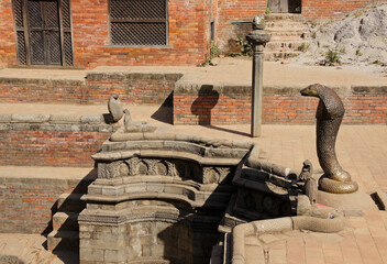 Naga Pokhari (water tank) encircled by stone and bronze cobras, Royal Palace in Durbar Square,...