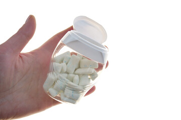 Bubble Gum. Chewing gum pads in a jar in hand isolated on a white background .Dental and oral...