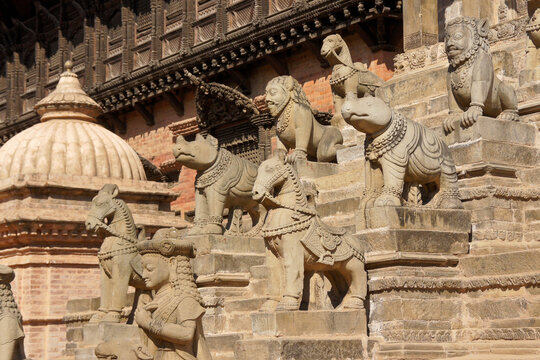 Carved stone attendants and animals flanking steps of Siddhi Lakshmi Mandir (Lohan Dega, Stone Temple), Durbar Square, Bhaktapur, Kathmandu Valley, Nepal