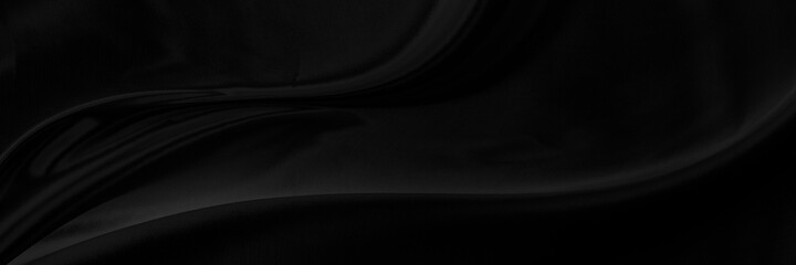 Black gray satin dark fabric texture luxurious shiny that is abstract silk cloth panorama background with patterns soft waves blur beautiful.