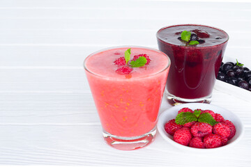Raspberry smoothie red colorful fruit juice milkshake blend beverage healthy high protein the taste yummy In glass drink episode morning on white wood background.