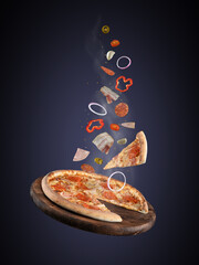 Levitation of food. falling ingredients of pizza products on a dark background