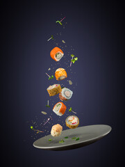 Levitation of food. Photo of falling sushi and rolls in a plate on a dark background.