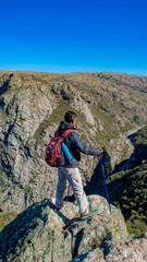 elderly person trekking looking towards the mountain