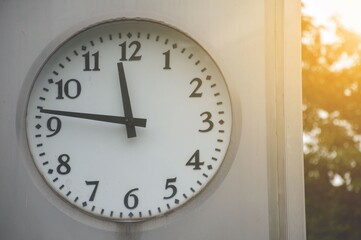 clock and sunlight in nature garden