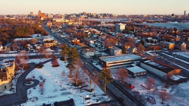 Aerial view of the Gatineau side of the Ottawa river heading towards Parliament Hill and downtown Ottawa and Hull  at sunset in winter