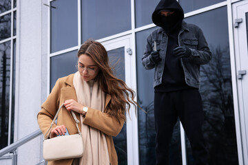 Man with knife stalking young woman near building