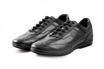 Pair of black leather shoes on white background.