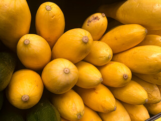 Close up of yellow squash in a stack