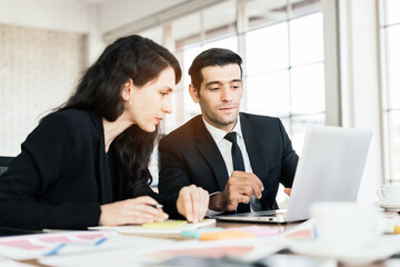 Caucasian business partnership consulting meeting with a smile. Brainstorming new business project finance investment for success on working table with a laptop. Internal meeting in office.