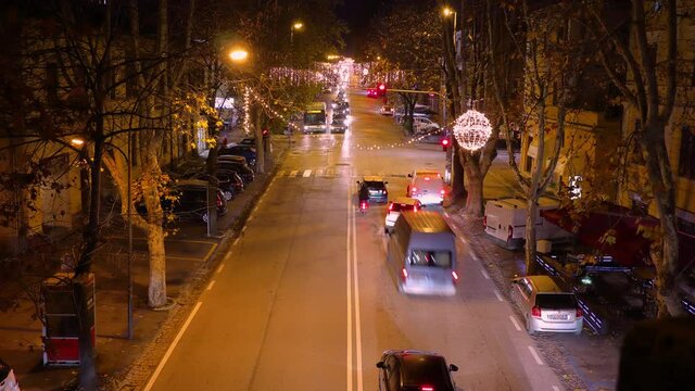 night traffic timelapse in the italian town of Jesi - traditional buildings with passing vehicles and pedestrians