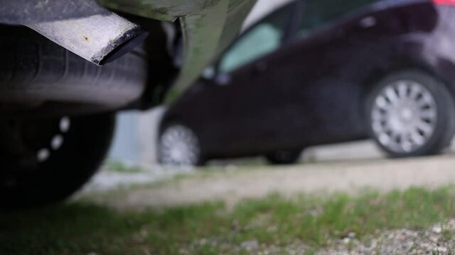 harmful toxic exhaust gas pollution - carbon monoxide, unburned hydrocarbons, nitrogen and sulfur oxides, carbonaceous particulate - rear view of a car with engine running - global warming risk
