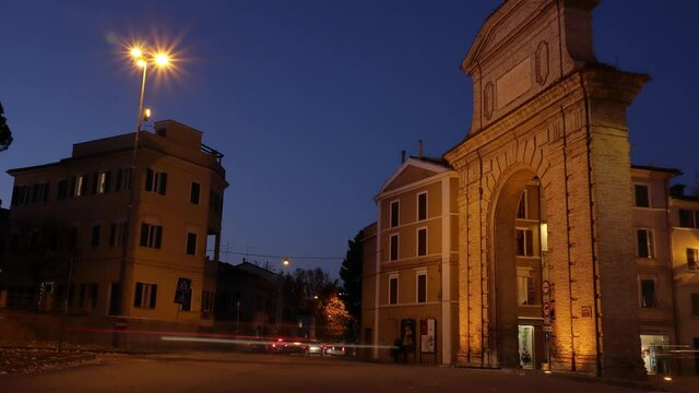 italian town called Jesi in a night traffic timelapse - traditional buildings with passing vehicles and pedestrians on the crossroads