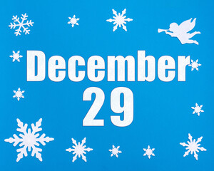 December 29th. Winter blue background with snowflakes, angel and a calendar date. Day 29 of month.