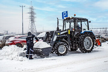 Clearing the parking lot of snow on a winter day