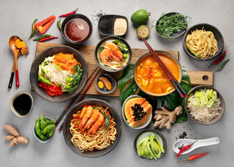 Asian dishes variety on gray background.