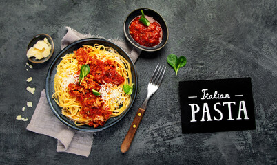 Spaghetti Bolognese on gray background.