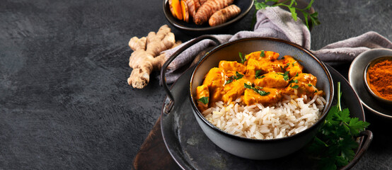 Indian butter chicken curry with basmati rice on dark background. - obrazy, fototapety, plakaty