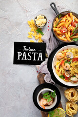 Pasta assortment on gray background.
