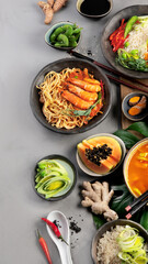 Asian dishes variety on gray background.