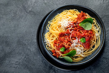 Spaghetti Bolognese on gray background.