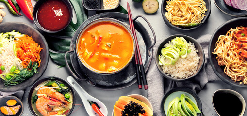 Asian dishes variety on gray background.