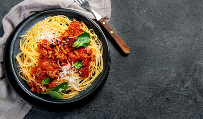 Spaghetti Bolognese on gray background.