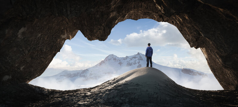 Adult Hiker Male standing inside a rocky mountain cave overlooking the nature scene. 3d Rendering. Aerial background landscape image from British Columbia, Canada. Adventure concept artwork