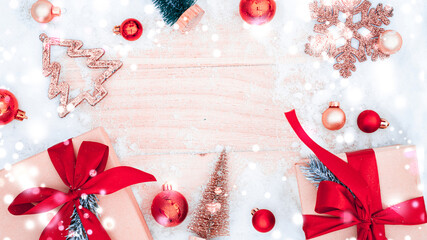 Xmas background table. Winter wooden decoration backdrop. Christmas board with old rustic wall, white frozen snow, golden balls and gift box. Minimal flat lay.