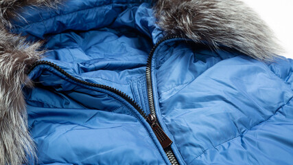 women winter fashion concept. blue jacket. down jacket with a hood. Winter outerwear for women on...