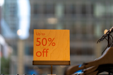 up to 50% off sign at clothing store
