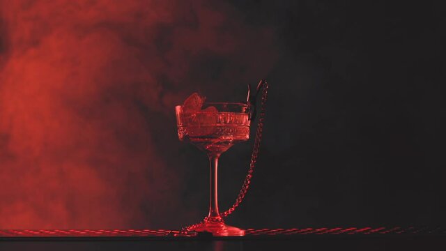 Sensual cocktail in smoke and red light
