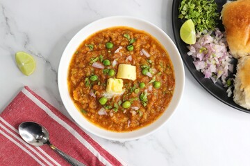 Indian Mumbai Street style Pav Bhaji, garnished with peas, raw onions, coriander, and Butter. Spicy...