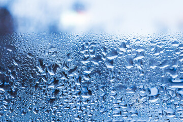 Abstract blue background. Liquid on dirty glass.Frozen water drops on glass,closeup,selective soft focus.Copy space.