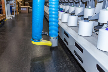 Itinerant cleaning machine at textile threads industry factory.