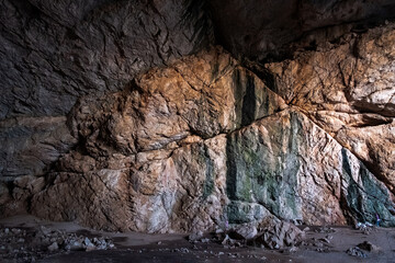 Akmeshit or Akmechet cave. Huge cavern with hole and green trees groving under.