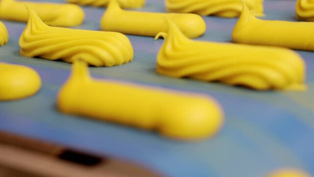 Moving confectionery on a conveyor line close-up.