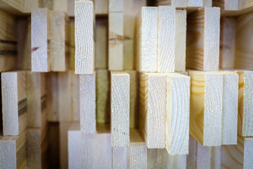 A large pile of wooden boards stored in a sawmill. Selective focus