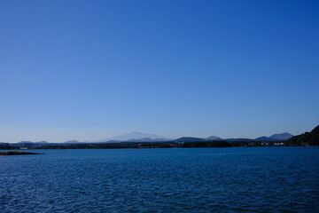 Blue sea and sky scenery of Seongsan Ilchulbong (UNESCO World Heritage Site) in Jeju Island, South Korea