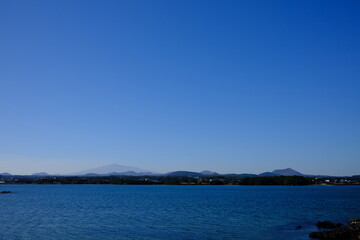 Blue sea and sky scenery of Seongsan Ilchulbong (UNESCO World Heritage Site) in Jeju Island, South Korea