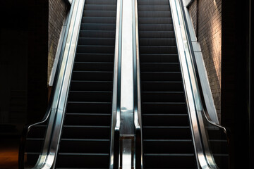 Escalators. Two Escalators in the shopping mall through to light.