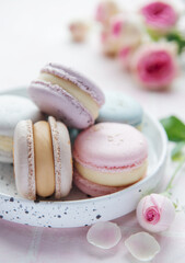 Beautiful colorful tasty macaroons on a pink tile background